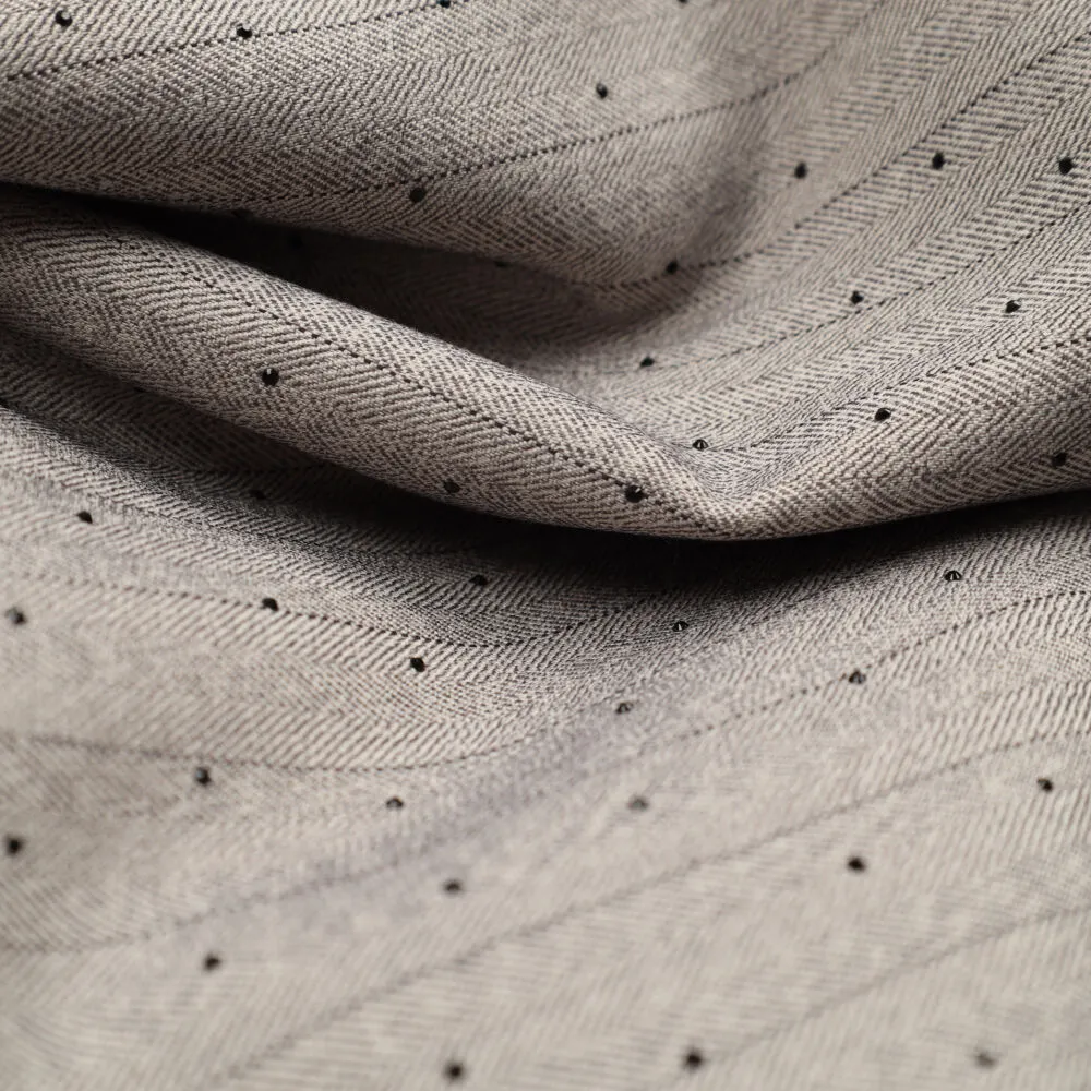 Pincy Diamonds close-up van glitter stippen op grijze visgraatweefstof